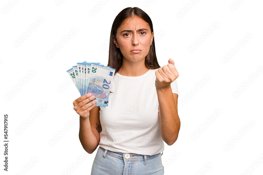 Young caucasian woman holding a banknotes isolated showing fist to camera, aggressive facial expression. Young caucasian woman holding a banknotes isolated showing fist to camera, aggressive facial expression.