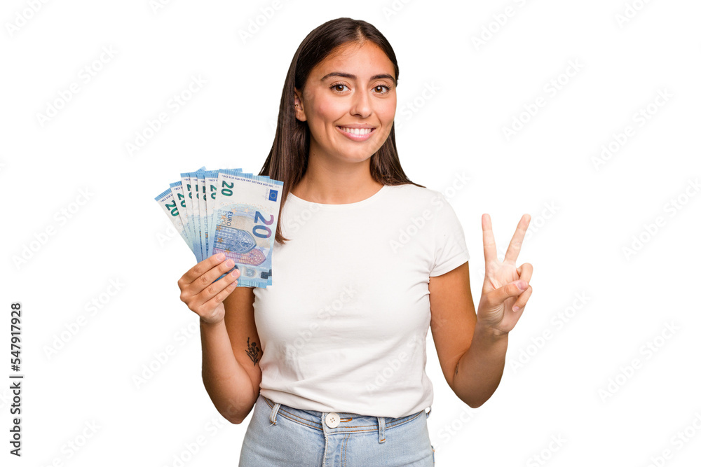 Young caucasian woman holding a banknotes isolated showing number two with fingers. Young caucasian woman holding a banknotes isolated showing number two with fingers.