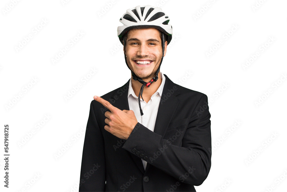Business Caucasian man wearing a bike helmet isolated smiling and pointing aside, showing something at blank space. Business Caucasian man wearing a bike helmet isolated smiling and pointing aside, showing something at blank space.