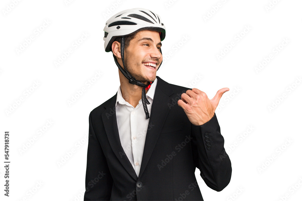 Business Caucasian man wearing a bike helmet isolated points with thumb finger away, laughing and carefree. Business Caucasian man wearing a bike helmet isolated points with thumb finger away, laughing and carefree.