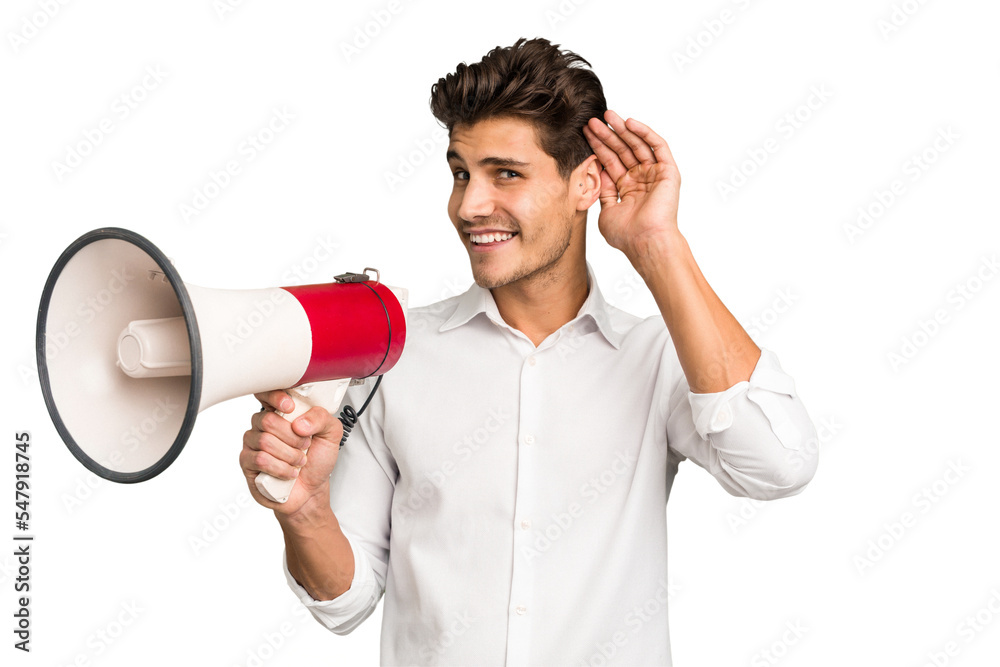 Young caucasian man holding megaphone isolated trying to listening a gossip. Young caucasian man holding megaphone isolated trying to listening a gossip.