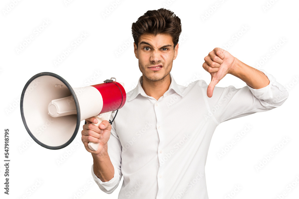 Young caucasian man holding megaphone isolated showing a dislike gesture, thumbs down. Disagreement concept. Young caucasian man holding megaphone isolated showing a dislike gesture, thumbs down. Disagreement concept.