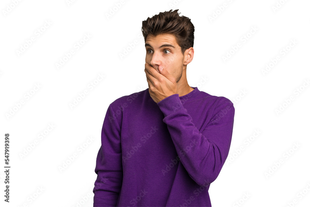 Young caucasian handsome man isolated thoughtful looking to a copy space covering mouth with hand. Young caucasian handsome man isolated thoughtful looking to a copy space covering mouth with hand.