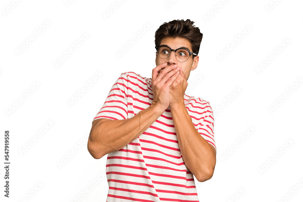 Young caucasian handsome man isolated thoughtful looking to a copy space covering mouth with hand. Young caucasian handsome man isolated thoughtful looking to a copy space covering mouth with hand.
