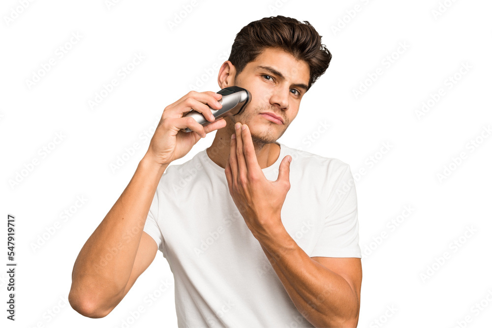 Young caucasian man shaving his beard with a razor isolated