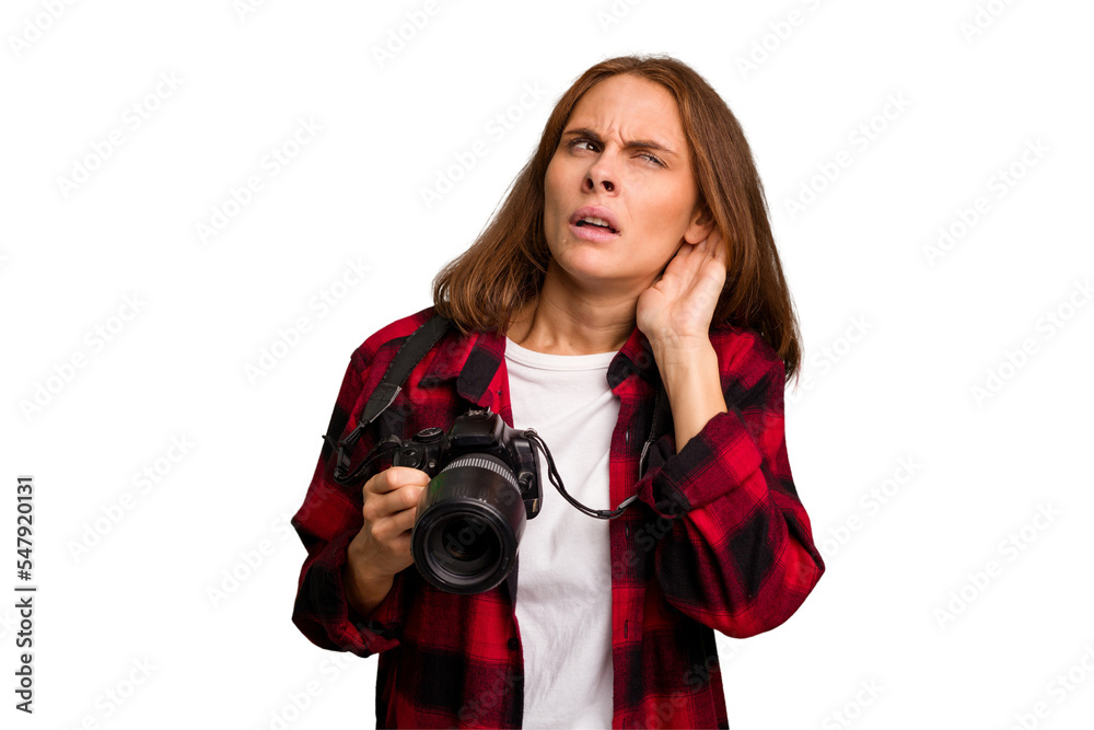 Fototapeta premium Young photographer caucasian woman isolated trying to listening a gossip.