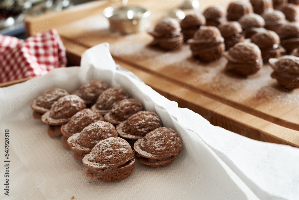 Placing homemade Christmas cookies in the form of nuts in a box Placing homemade Christmas cookies in the form of nuts in a box