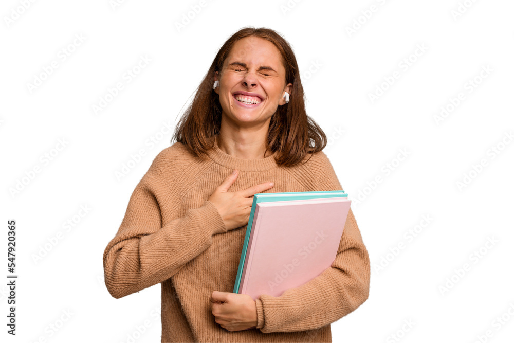 Young student woman holding a books isolated laughs out loudly keeping hand on chest. Young student woman holding a books isolated laughs out loudly keeping hand on chest.