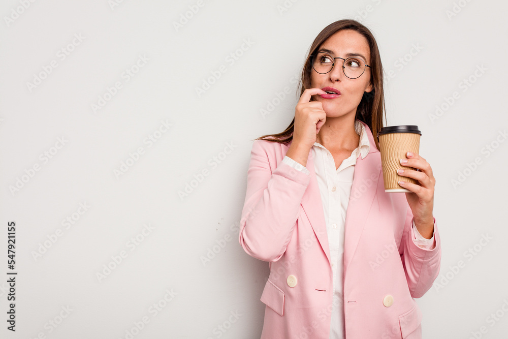 Business caucasian woman holding a take away coffee isolated on white background relaxed thinking about something looking at a copy space. Business caucasian woman holding a take away coffee isolated on white background relaxed thinking about something looking at a copy space.