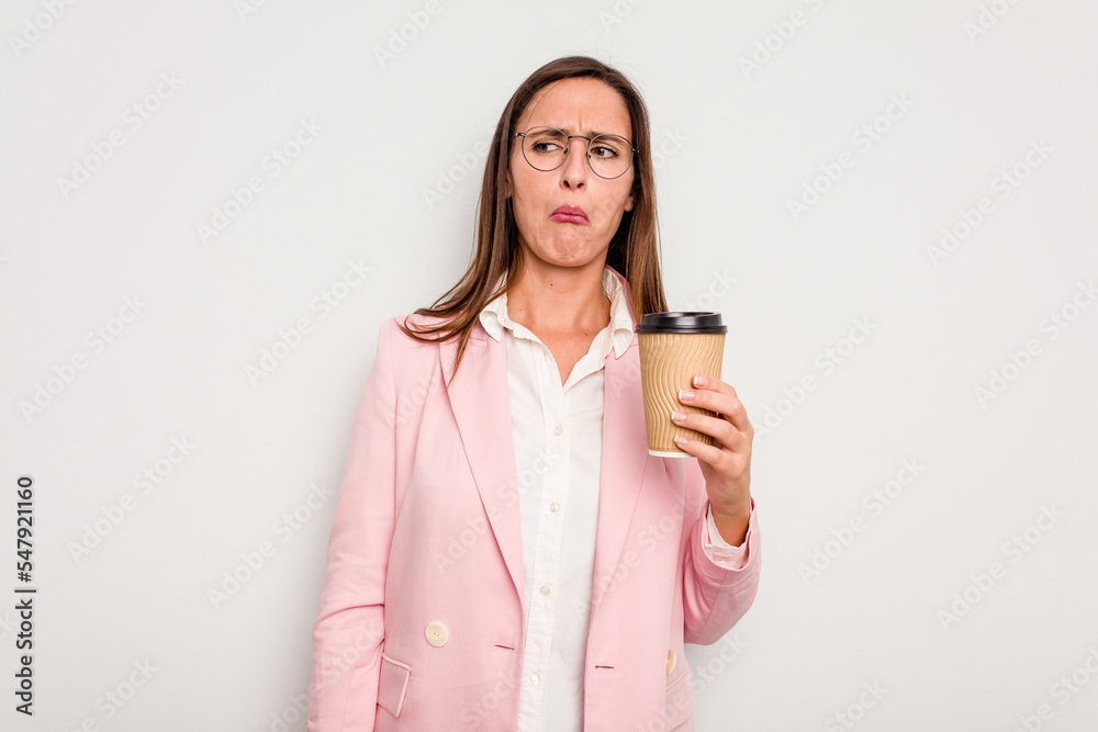 Business caucasian woman holding a take away coffee isolated on white background confused, feels doubtful and unsure. Business caucasian woman holding a take away coffee isolated on white background confused, feels doubtful and unsure.