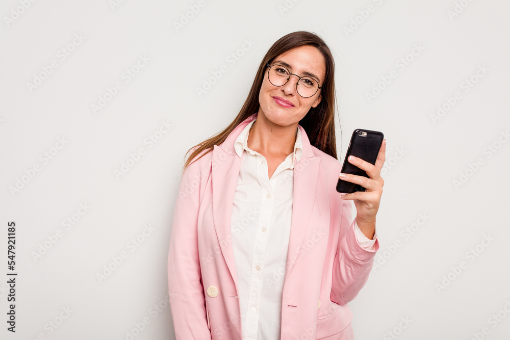 Business caucasian woman holding a mobile phone isolated on white background happy, smiling and cheerful. Business caucasian woman holding a mobile phone isolated on white background happy, smiling and cheerful.