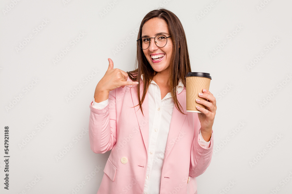 Business caucasian woman holding a take away coffee isolated on white background showing a mobile phone call gesture with fingers. Business caucasian woman holding a take away coffee isolated on white background showing a mobile phone call gesture with fingers.