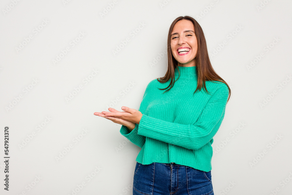 Young caucasian cute woman isolated on white background holding a copy space on a palm. Young caucasian cute woman isolated on white background holding a copy space on a palm.