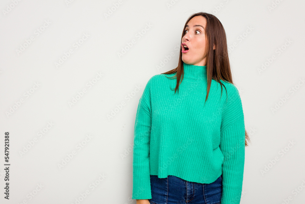 Young caucasian cute woman isolated on white background being shocked because of something she has seen. Young caucasian cute woman isolated on white background being shocked because of something she has seen.