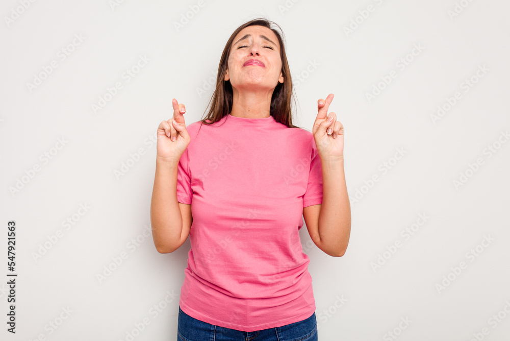 Young caucasian cute woman isolated on white background crossing fingers for having luck Young caucasian cute woman isolated on white background crossing fingers for having luck