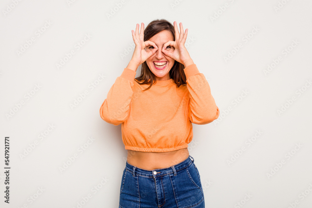 Young caucasian cute woman isolated on white background excited keeping ok gesture on eye. Young caucasian cute woman isolated on white background excited keeping ok gesture on eye.