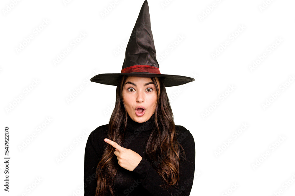 Young caucasian woman dressed as a witch isolated on green chroma background pointing to the side Young caucasian woman dressed as a witch isolated on green chroma background pointing to the side