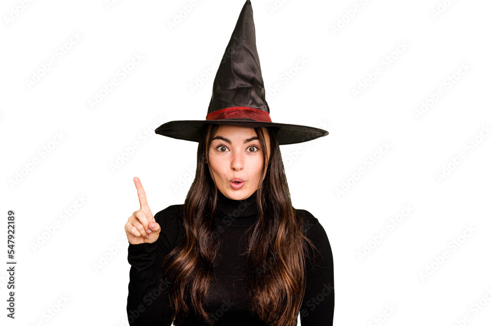 Young caucasian woman dressed as a witch isolated on green chroma background having some great idea, concept of creativity.