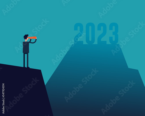 Businessman looking at the fuzziness of the year 2023 through telescope