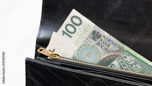 Polish money in a black wallet, holding money in a wallet, 100 polish note, Poland’s legal tender,, złotówki, polskie złote, PLN photo