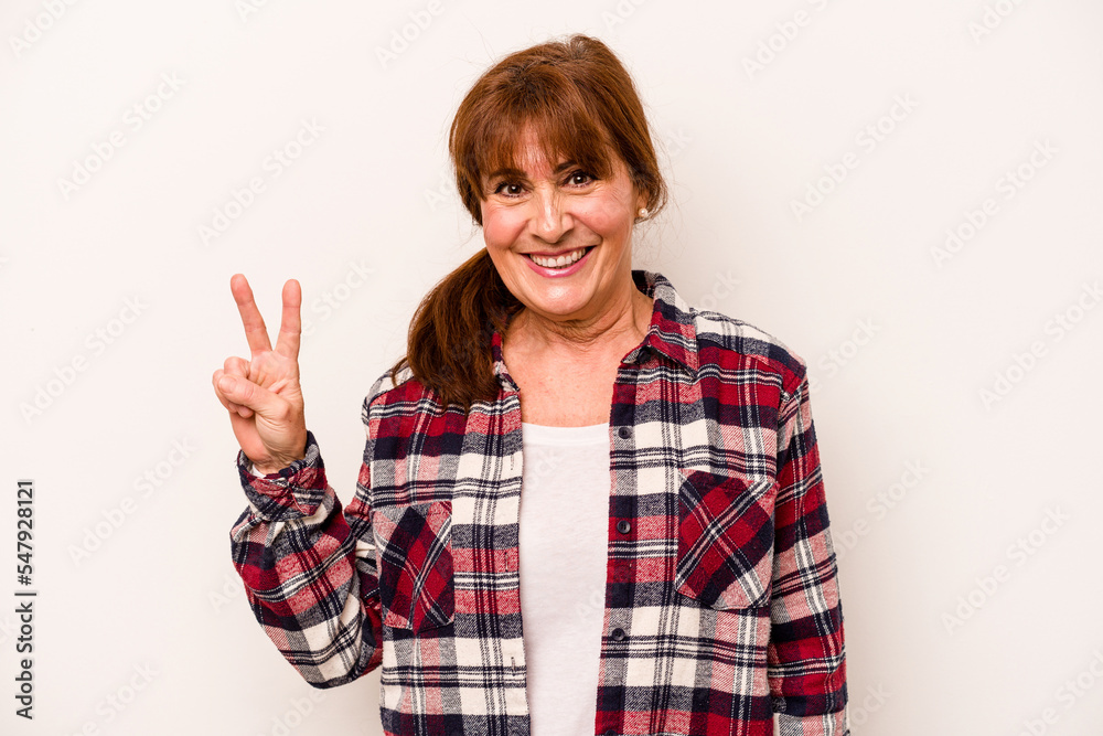 Middle age caucasian woman isolated on white background showing victory sign and smiling broadly. Middle age caucasian woman isolated on white background showing victory sign and smiling broadly.