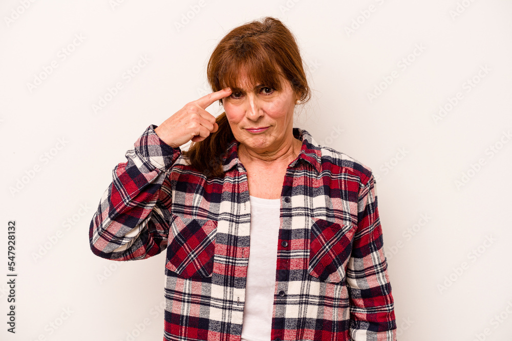 Middle age caucasian woman isolated on white background pointing temple with finger, thinking, focused on a task. Middle age caucasian woman isolated on white background pointing temple with finger, thinking, focused on a task.