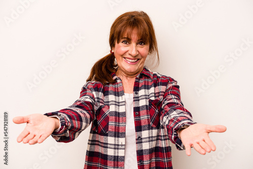 Middle age caucasian woman isolated on white background showing a welcome expression.