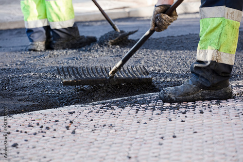 asphalt in the city operators working with uniform