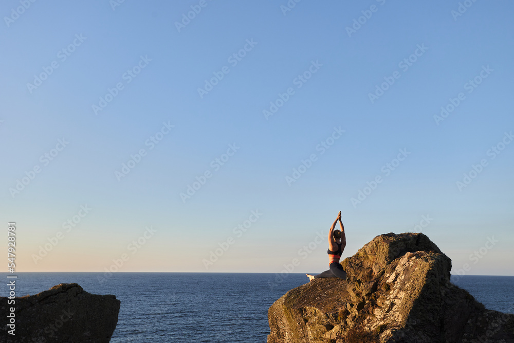 Stunning Landscape with healthy woman doing yoga pose, outdoor.