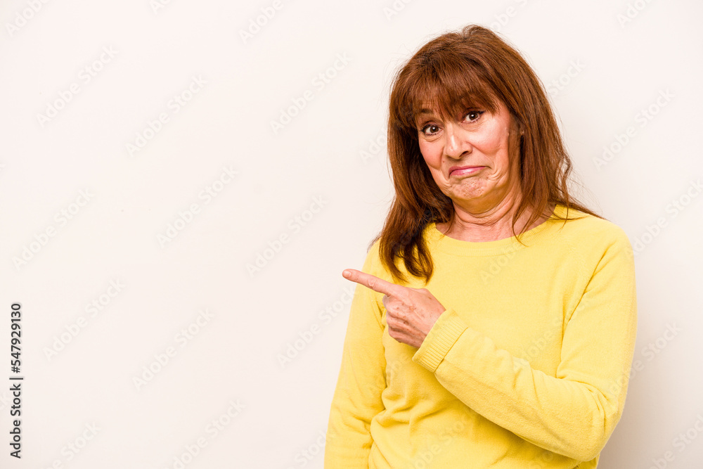 Middle age caucasian woman isolated on white background smiling and pointing aside, showing something at blank space. Middle age caucasian woman isolated on white background smiling and pointing aside, showing something at blank space.