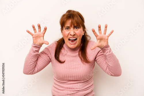 Middle age caucasian woman isolated on white background showing claws imitating a cat, aggressive gesture.