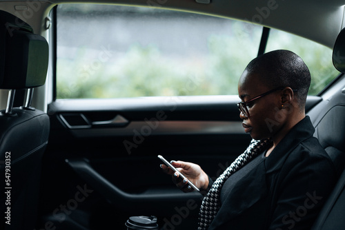 Businesswoman in backseat of car. photo