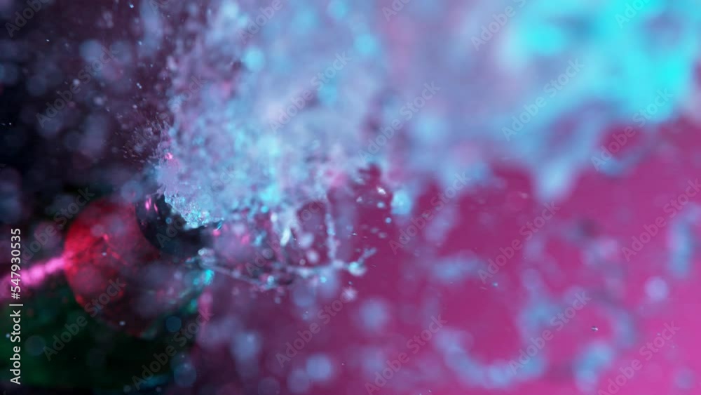 Super slow motion of Champagne explosion with flying cork closure, neon colors, opening champagne bottle closeup. Super slow motion of Champagne explosion with flying cork closure, neon colors, opening champagne bottle closeup.
