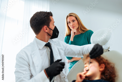 Worried mom with daughter at dentist.
