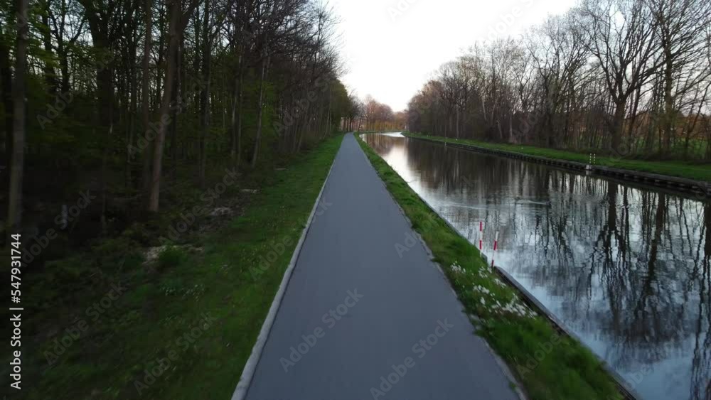 Drone shot along a Canal in Belgium, Europe, in fall or winter season with reflections of the trees in the water. . High quality 4k footage Drone shot along a Canal in Belgium, Europe, in fall or winter season with reflections of the trees in the water. . High quality 4k footage