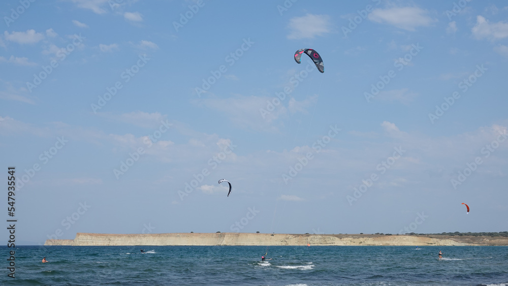 Kite Surfers in action on Waves in sea. Kitesurfs make slalom on the waves. Serial images Imbros Island. Gokceada, Canakkale Turkey 08.20.2022
