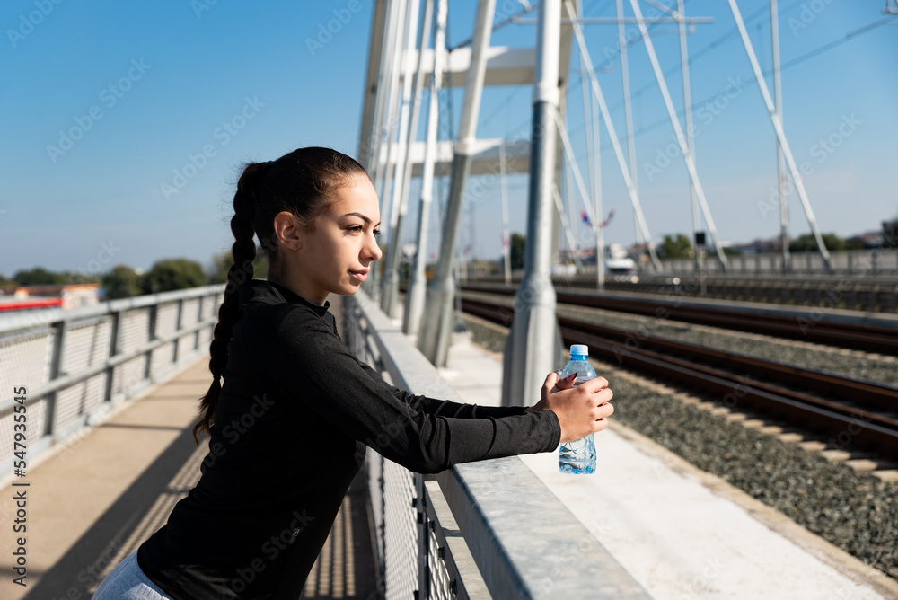 Obraz premium Young school or college university student fit teen girl morning routine of exercising outdoor. Fitness female morning workout training for healthy life before study time.