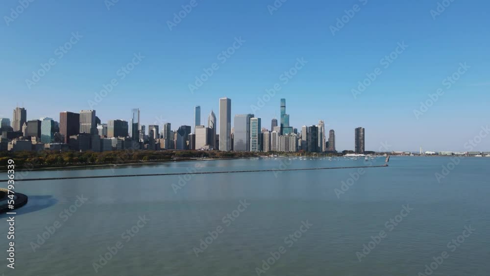 rising drone view above lake michigan with chicago buildings in backround rising drone view above lake michigan with chicago buildings in backround