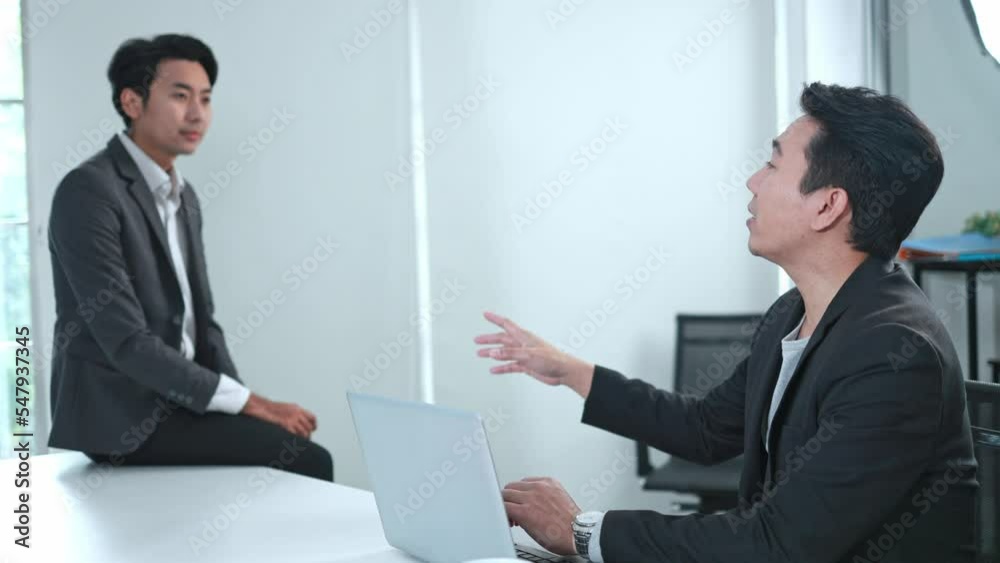 Asian businessmen talking and chatting with each other in the office slow motion Asian businessmen talking and chatting with each other in the office slow motion