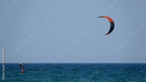Professional Kite Surfer in action on Waves in sea. Kitesurf makes slalom on the waves. Serial images Imbros Island. Gokceada, Canakkale Turkey 08.20.2022