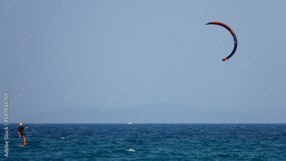 Professional Kite Surfer in action on Waves in sea. Kitesurf makes slalom on the waves. Serial images Imbros Island. Gokceada, Canakkale Turkey 08.20.2022