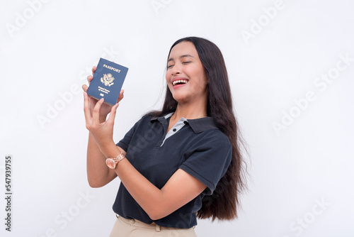 A happy asian woman celebrating her newly acquired US passport. Isolated on a white background.