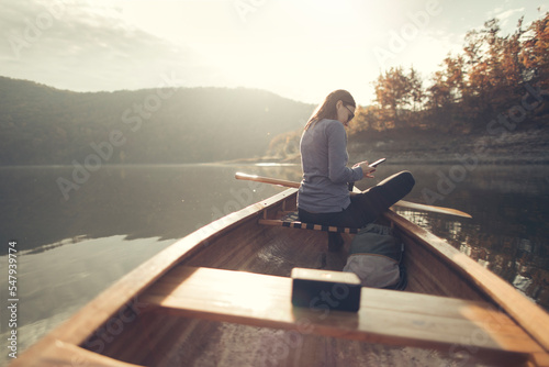 Side view of woman enjoy autumn in canoe