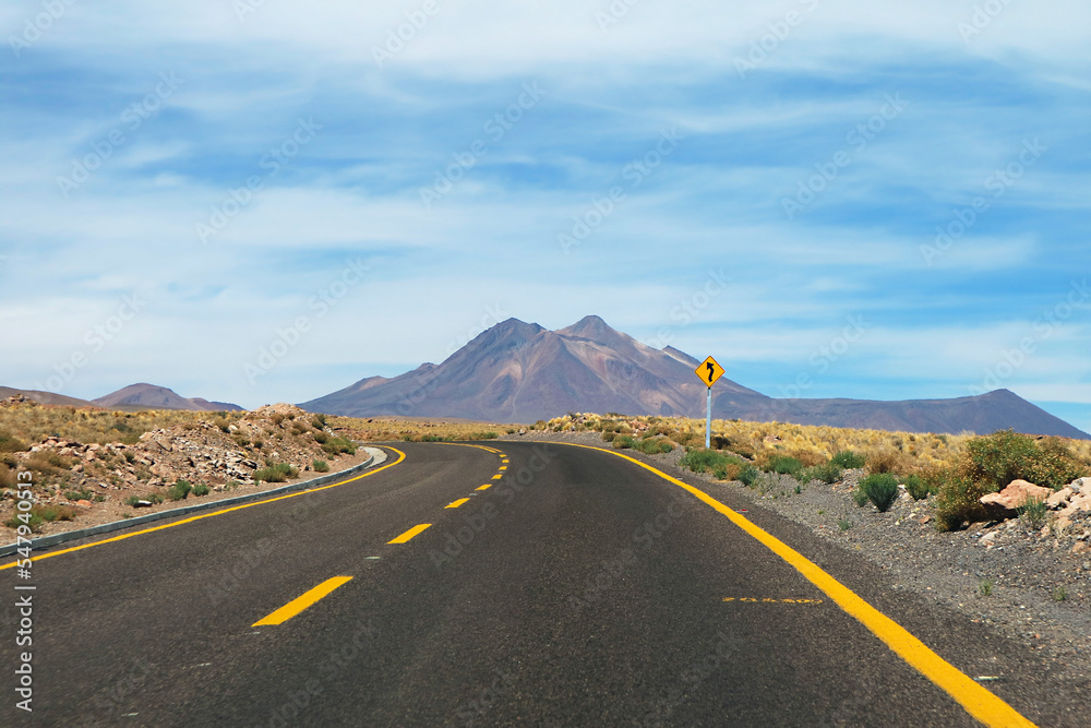 Curvy Road Signpost on the Empty Desert Road in Atacama Desert, Antofagasta Region, Northern Chile, South America Curvy Road Signpost on the Empty Desert Road in Atacama Desert, Antofagasta Region, Northern Chile, South America