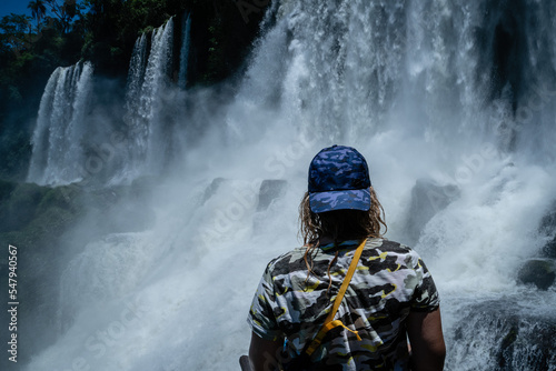 tourist woman looks at iguazu falls