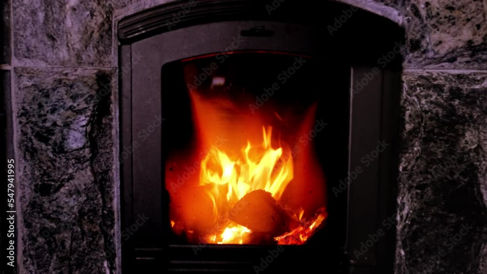 bright orange flame, firewood burns in stove, fireplace in dark room, burning stone and enjoying warmth, cozy winter evening at home concept, relaxing by home fire, energy problem of population bright orange flame, firewood burns in stove, fireplace in dark room, burning stone and enjoying warmth, cozy winter evening at home concept, relaxing by home fire, energy problem of population