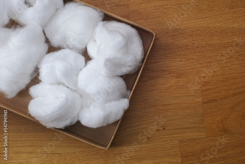 A cardboard box full of cotton balls