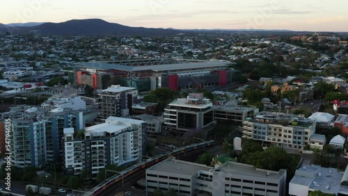 Establishing aerial shot capturing famous suncorp stadium in milton, inner city suburb with train crossing from merivale railway bridge and traffics on riverside expressway and Brisbane M3 highway. photo