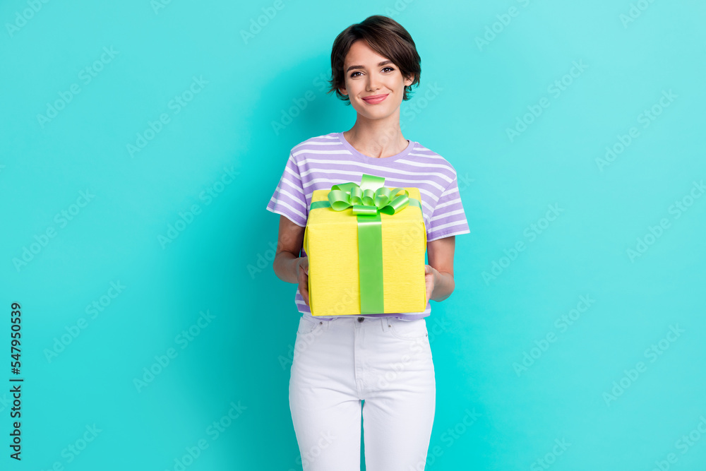 Portrait of pretty cheerful gorgeous girl with bob hairstyle wear striped t-shirt give you present isolated on turquoise color background Portrait of pretty cheerful gorgeous girl with bob hairstyle wear striped t-shirt give you present isolated on turquoise color background