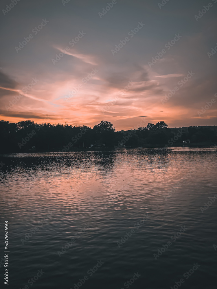 Naklejka premium sunset over the river
